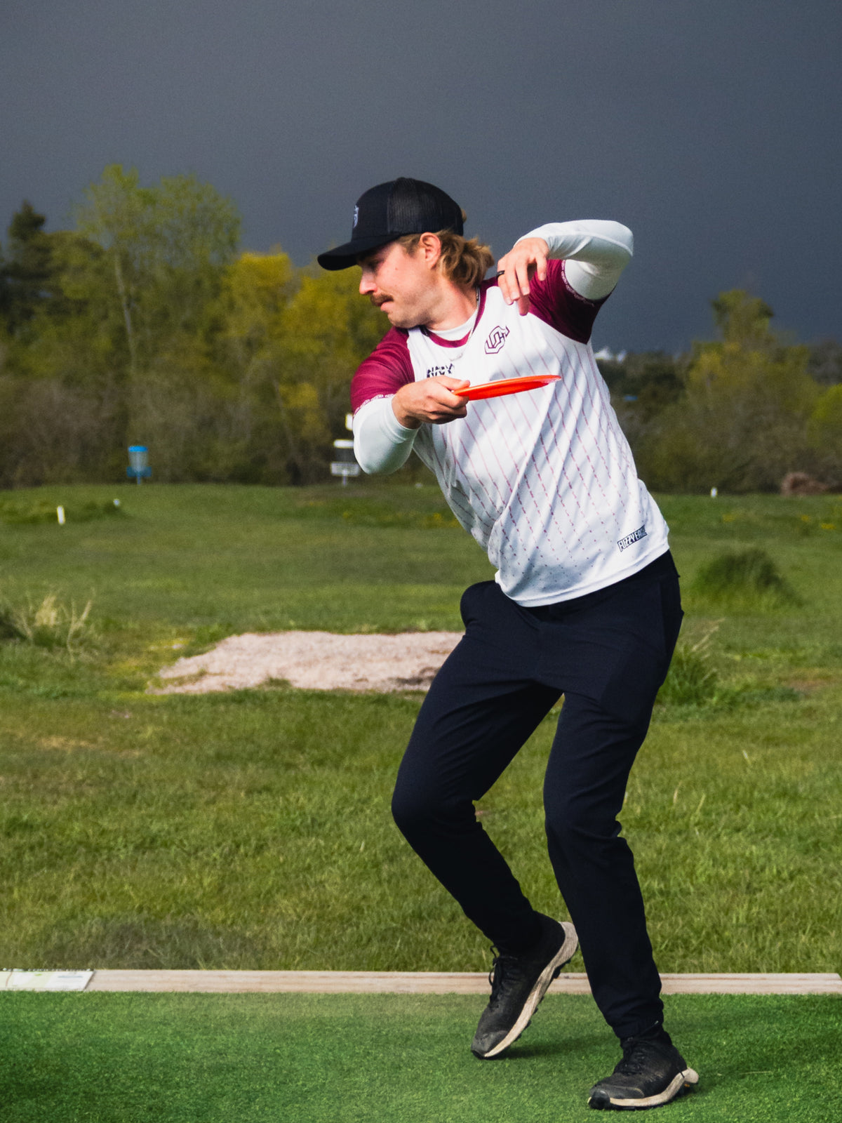 A player throwing a disc on the course